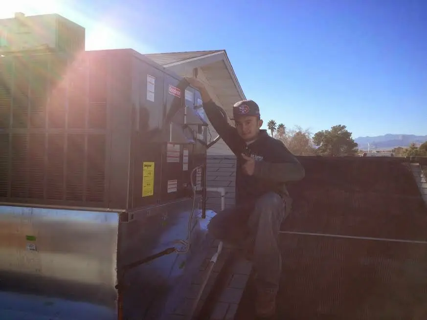 HVAC technician performing HVAC Inspection on a rooftop unit in Solon